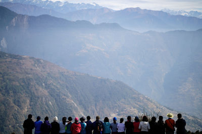 People standing against mountains