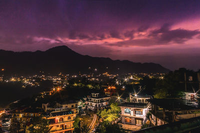 High angle view of illuminated cityscape against sky during sunset