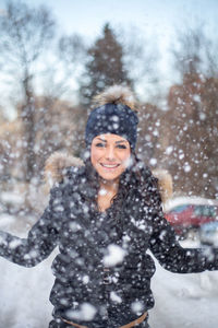 Portrait of smiling young woman during winter