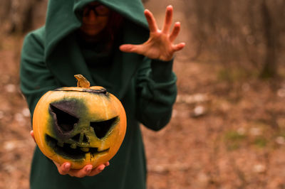 Portrait of woman with pumpkin