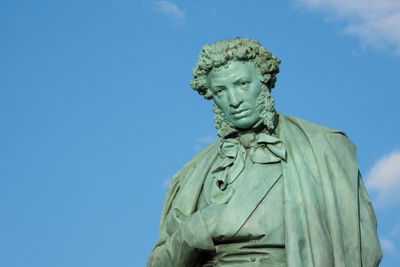 Low angle view of statue against blue sky