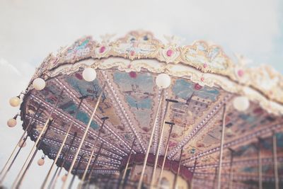 Low angle view of carousel against sky