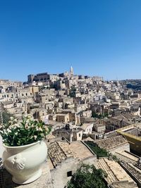 High angle view of buildings against clear blue sky