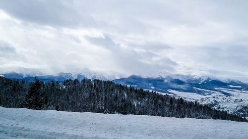 Scenic view of mountains against sky during winter