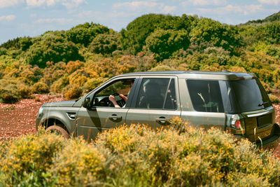 Person driving car in desert