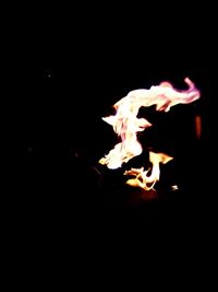 Close-up of fire over black background