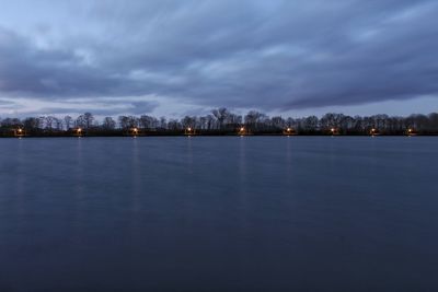 Scenic view of lake against sky at dusk