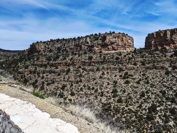 Rock formations on landscape against sky