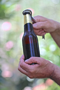 Close-up of hand holding bottle