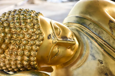 Close-up of buddha statue against building