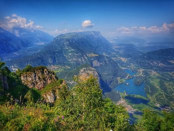 Scenic view of land and mountains against sky