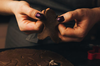 Close-up of hand holding gingerbread cookies