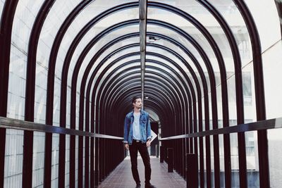 Full length of young man walking in covered walkway