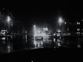 Illuminated city street during rainy season at night