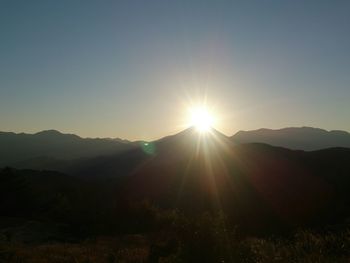 Sun shining over mountains