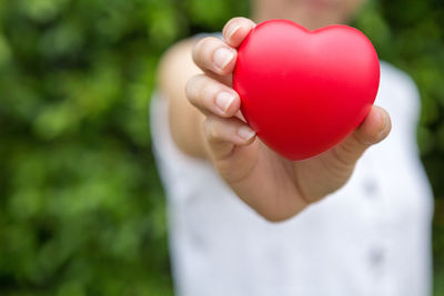 Close-up of hand holding heart shape