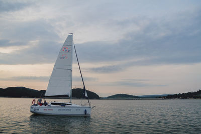 Sailboat sailing on sea against sky