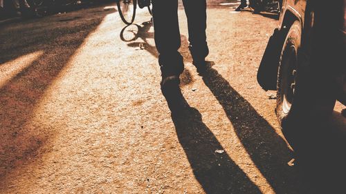 Low section of people walking on road