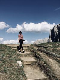 People walking on road against sky