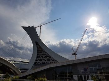 Low angle view of bridge against cloudy sky