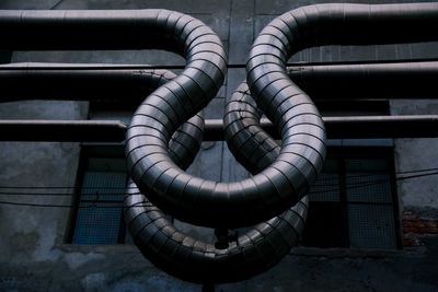 Low angle view of air ducts against old factory