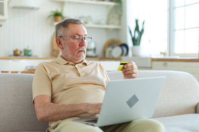 Young man using laptop at home