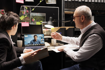 Side view of man using digital tablet in office