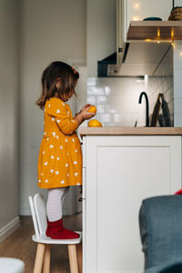 Rear view of woman standing at home