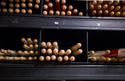 Close-up of drumsticks in shelf