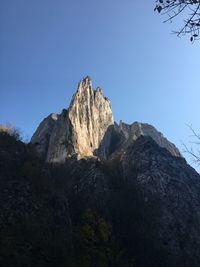 Low angle view of rock formation against sky