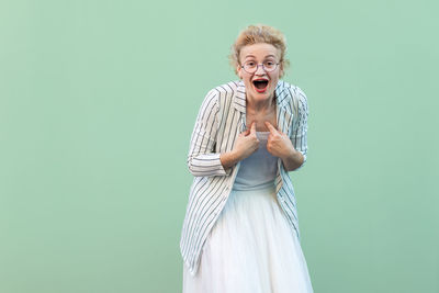 Young woman standing against white background