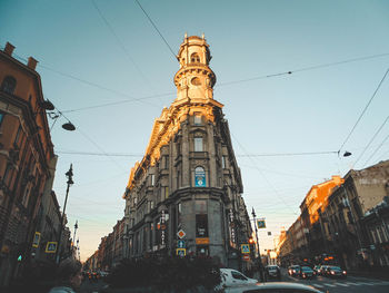 Low angle view of street amidst buildings against sky