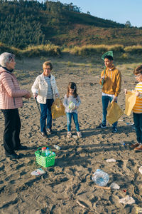 Family cleaning beach together