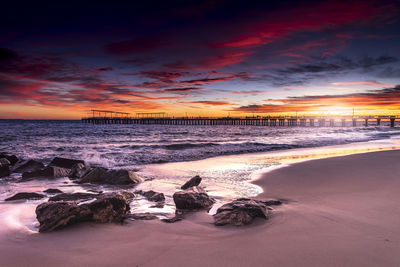 Scenic view of beach against sky during sunset