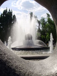 Fountain in park against sky