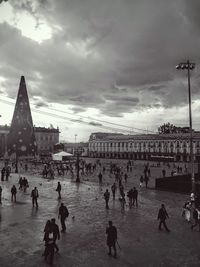 People against cloudy sky