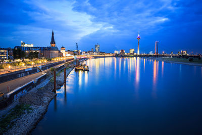 View of bridge over river at night