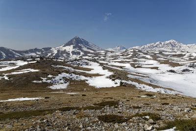 Scenic view of snowcapped mountains against sky