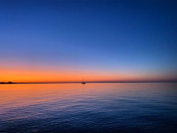 Scenic view of sea against clear sky during sunset