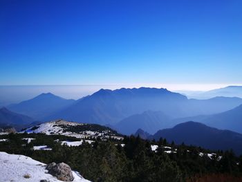 Scenic view of mountains against clear blue sky