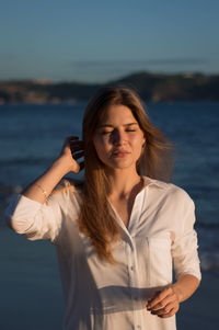 Young woman standing at beach