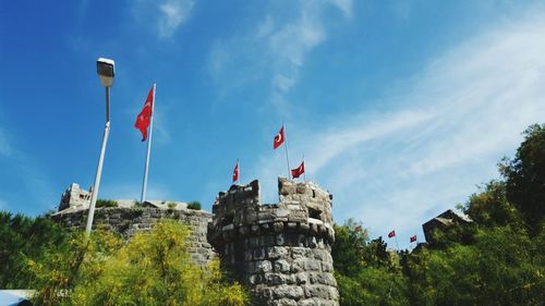 Low angle view of flag against blue sky