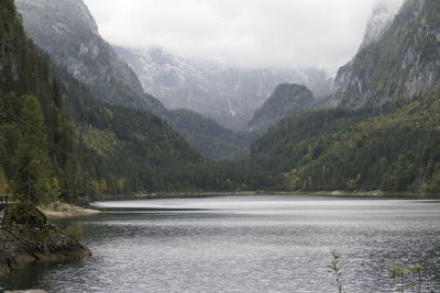 Scenic view of river by mountains