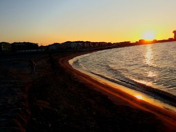 Scenic view of river at sunset