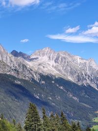 Scenic view of mountains against blue sky