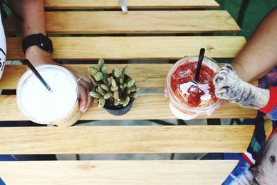 Midsection of man holding food on table