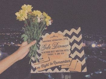 Close-up of hand holding flower bouquet