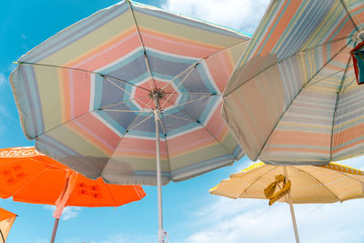 Low angle view of umbrellas against sky
