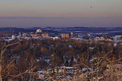 High angle view of buildings in city during sunset