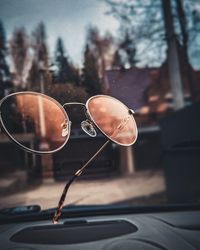 Close-up of sunglasses on car